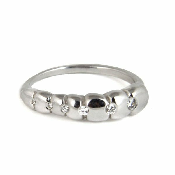 18k white gold ring with 6 diamonds as a conceptual spinal column.